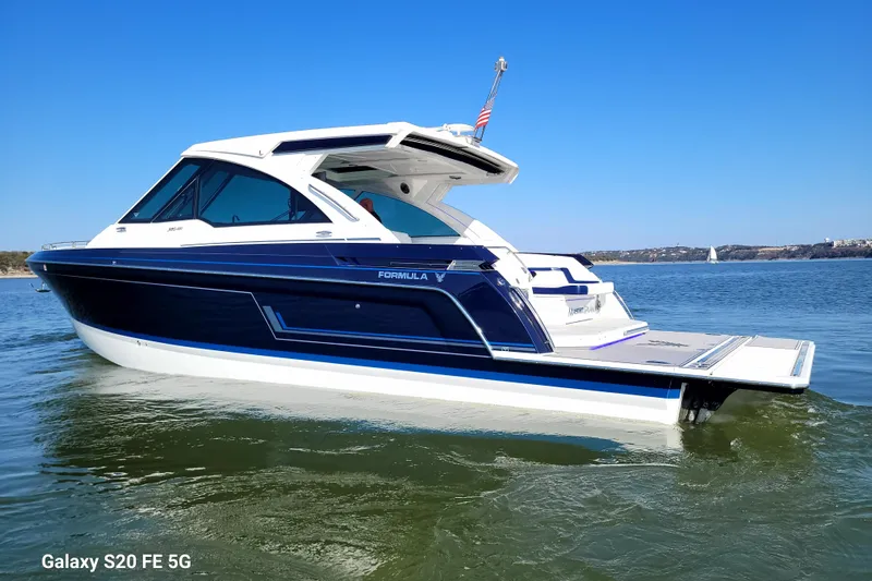 Master Plan Yacht Photos Pics 2023 Formula 380 Super Sport Crossover I/O boat on calm water, clear blue sky.