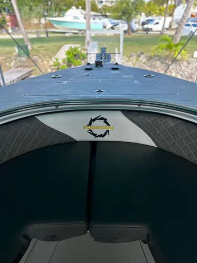  Yacht Photos Pics 2003 Fountain 34 CC boat interior with logo, docked outdoors.