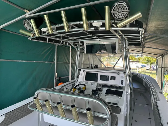  Yacht Photos Pics 2003 Fountain 34 CC boat interior with fishing rod holders and control panel.