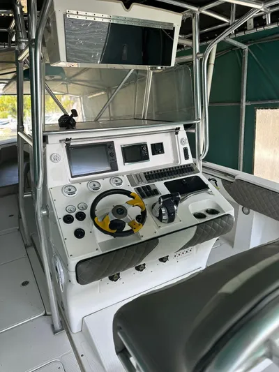  Yacht Photos Pics 2003 Fountain 34 CC boat cockpit with steering wheel and navigation controls.