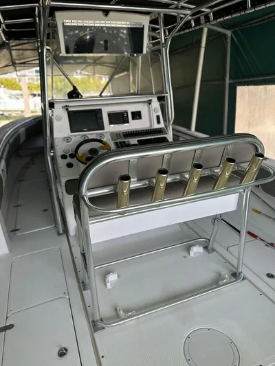  Yacht Photos Pics 2003 Fountain 34 CC boat interior with helm, rod holders, and navigation equipment.