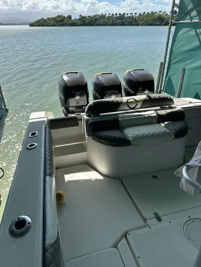  Yacht Photos Pics 2003 Fountain 34 CC boat with triple outboard motors on a calm lake.