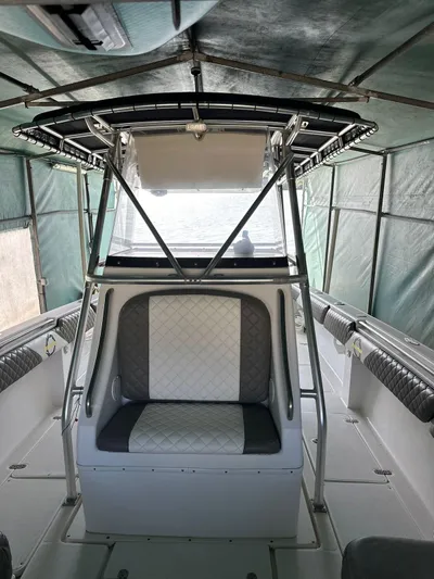  Yacht Photos Pics 2003 Fountain 34 CC boat interior with seating and canopy, showcasing sleek design and comfort.