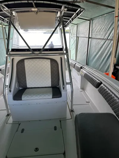  Yacht Photos Pics 2003 Fountain 34 CC boat interior with cushioned seating and canopy.