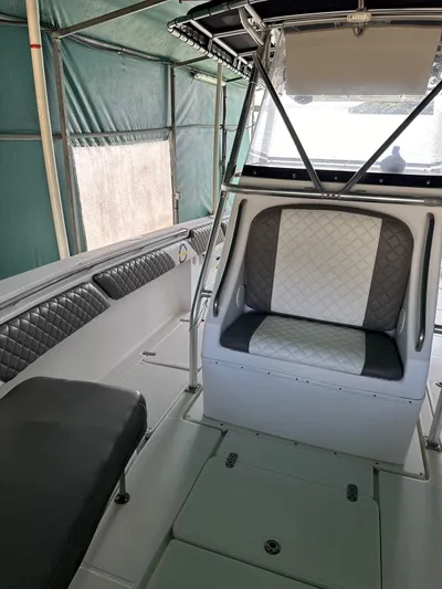  Yacht Photos Pics Interior of a 2003 Fountain 34 CC boat with cushioned seating and canopy.