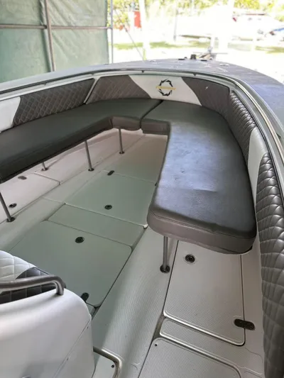  Yacht Photos Pics 2003 Fountain 34 CC boat interior with cushioned seating and storage compartments.