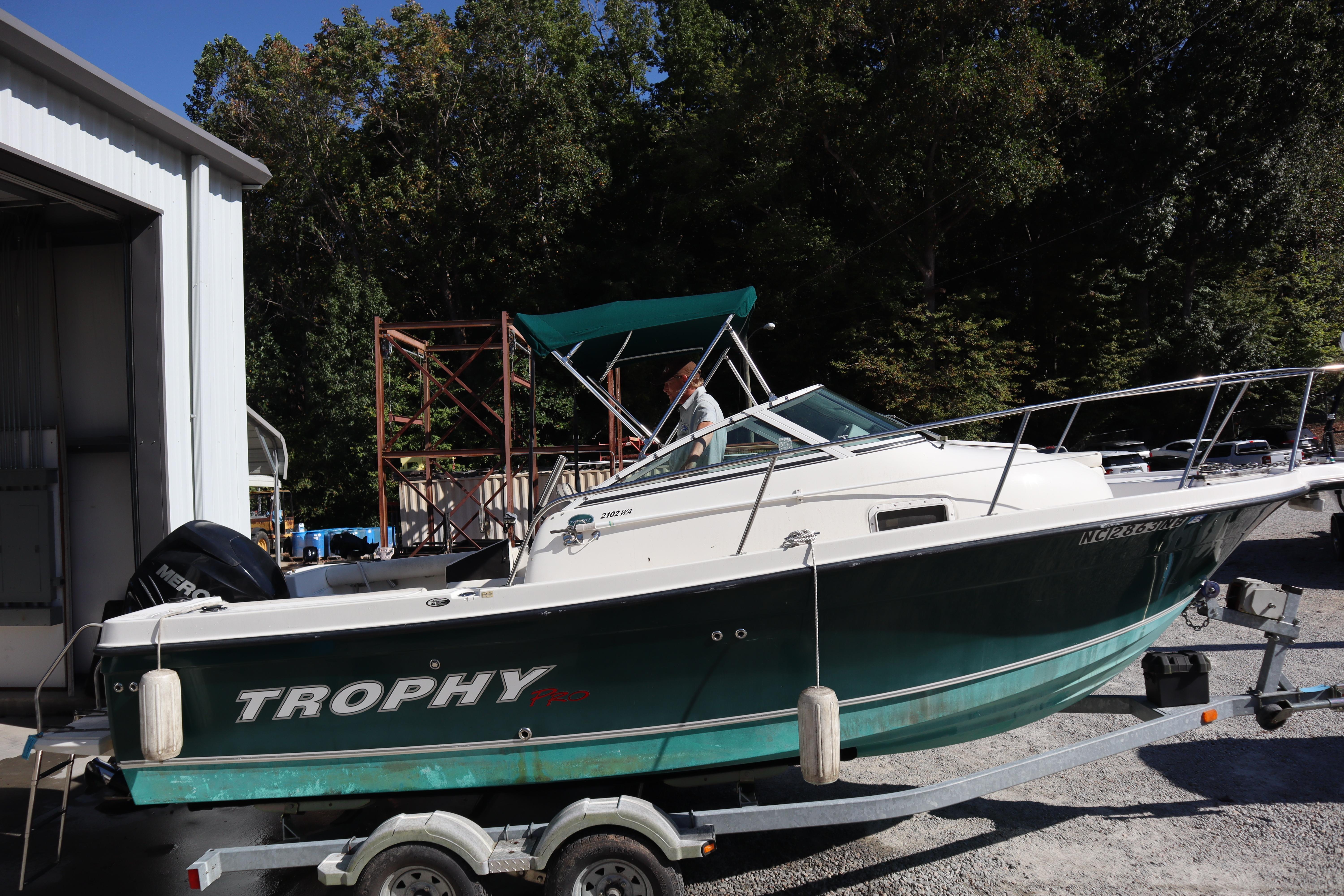 2008 Trophy 2102 Walkaround boat on trailer near a storage facility.