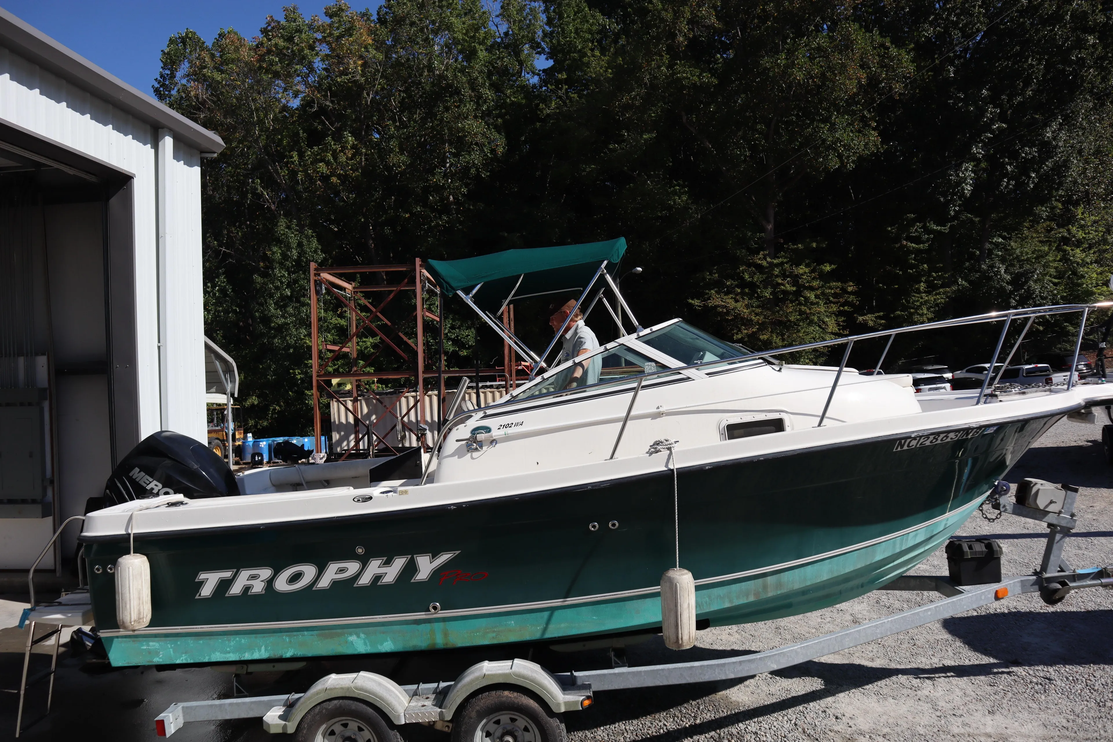 2008 Trophy 2102 Walkaround boat on trailer near a storage facility.