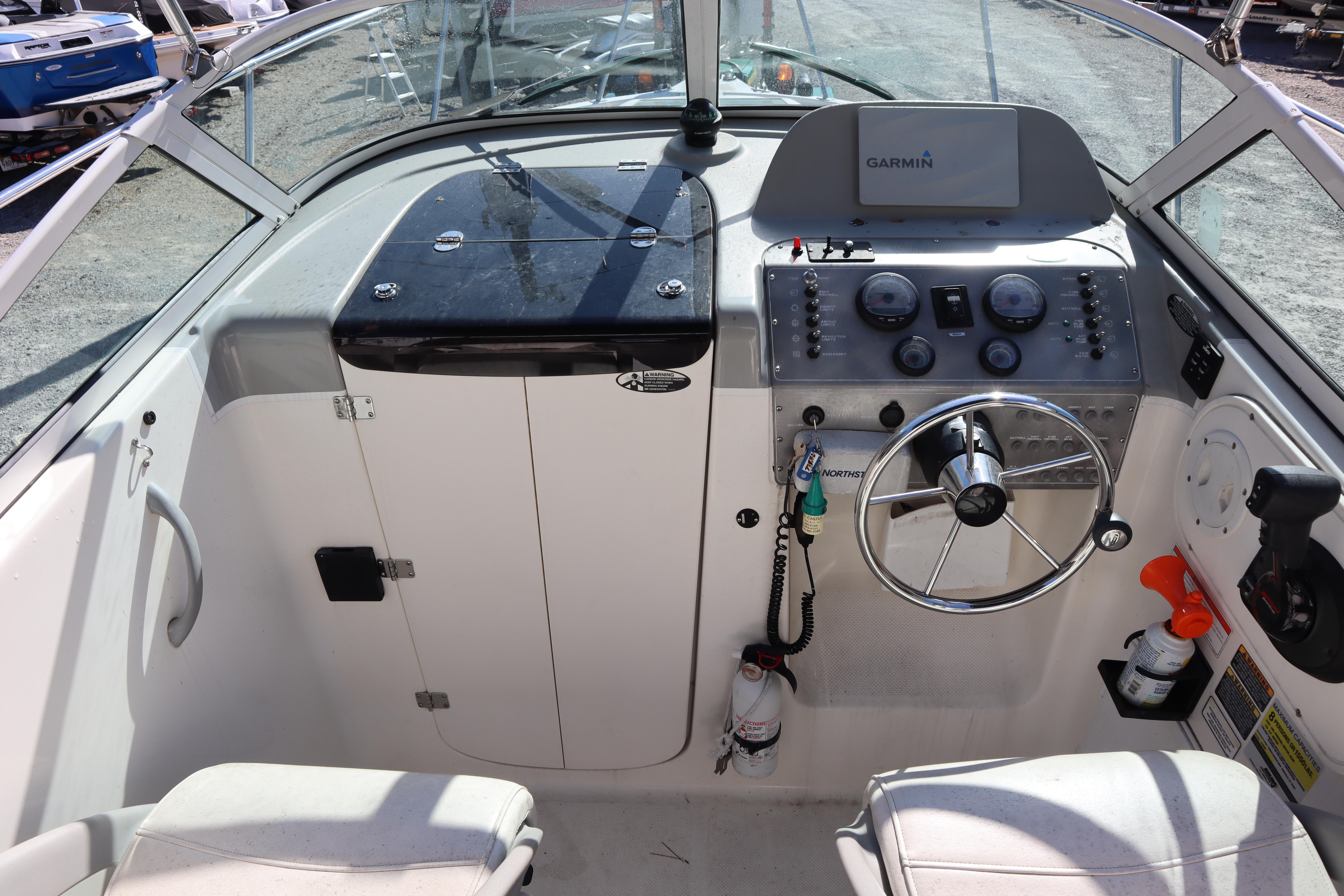 2008 Trophy 2102 Walkaround boat cockpit with steering wheel and Garmin navigation system.