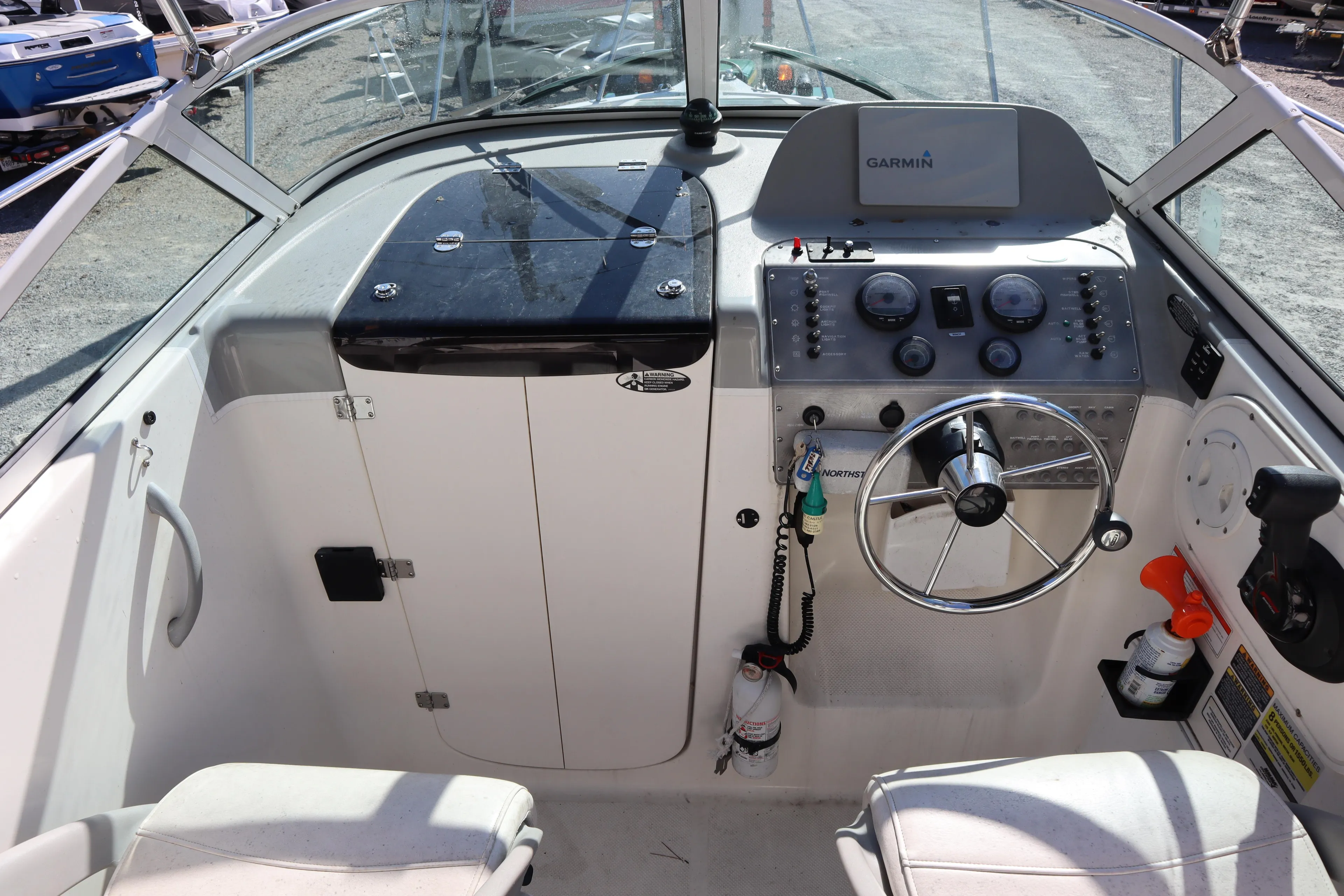 2008 Trophy 2102 Walkaround boat cockpit with steering wheel and Garmin navigation system.