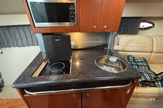  Yacht Photos Pics 2009 Formula 350 Sun Sport boat interior kitchen with microwave, stove, and sink.