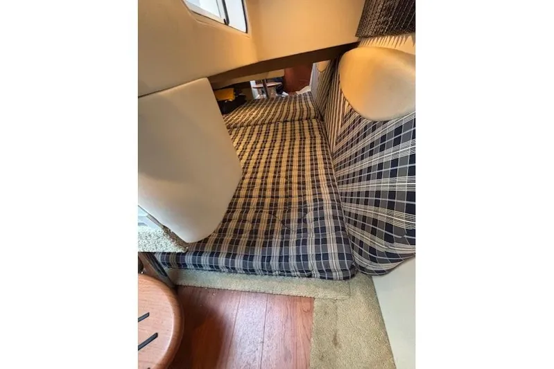  Yacht Photos Pics Interior cabin of 2009 Formula 350 Sun Sport with plaid upholstery and wooden flooring.