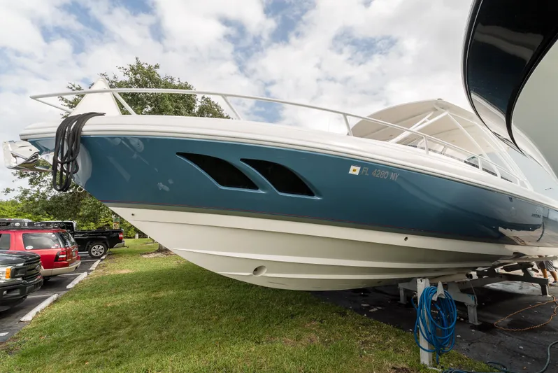  Yacht Photos Pics 2010 Intrepid 370 Cuddy boat on display, blue hull, parked on grass.