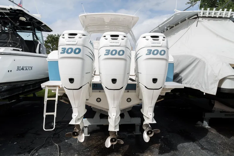  Yacht Photos Pics 2010 Intrepid 370 Cuddy with triple 300 horsepower engines, docked outdoors.