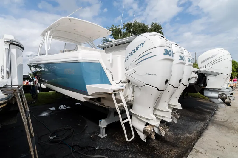  Yacht Photos Pics 2010 Intrepid 370 Cuddy boat with triple Mercury 300 engines, displayed outdoors.