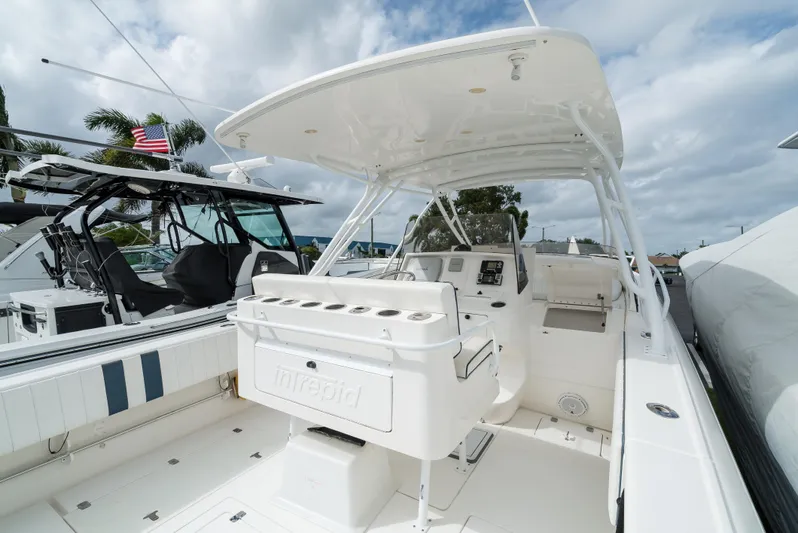  Yacht Photos Pics 2010 Intrepid 370 Cuddy boat with spacious deck and helm, docked under cloudy skies.