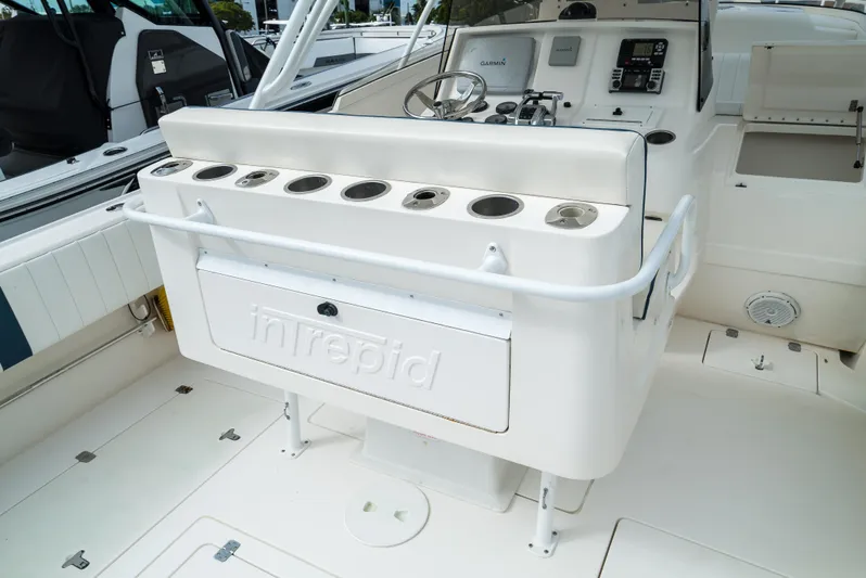  Yacht Photos Pics 2010 Intrepid 370 Cuddy boat interior with fishing rod holders and control panel.