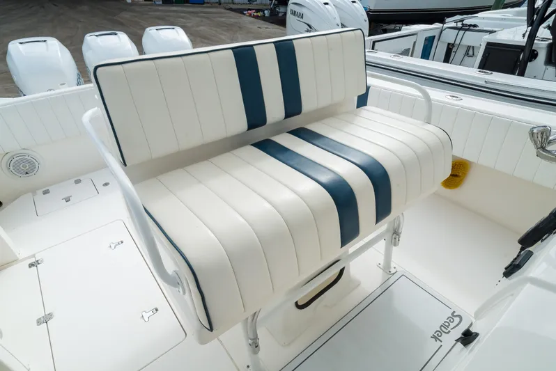  Yacht Photos Pics Intrepid 370 Cuddy 2010 boat seat with blue and white striped upholstery.