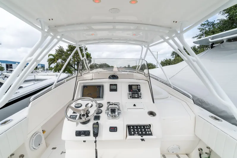  Yacht Photos Pics 2010 Intrepid 370 Cuddy boat cockpit with steering wheel and control panel.