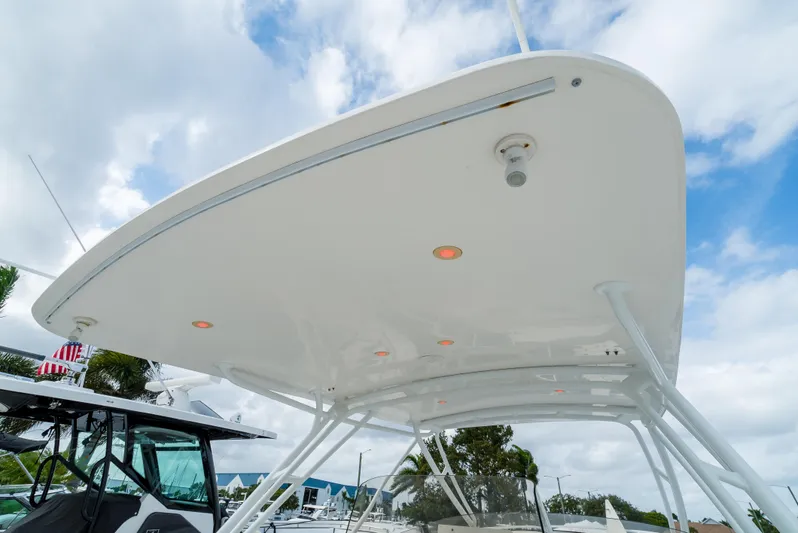  Yacht Photos Pics 2010 Intrepid 370 Cuddy boat canopy with integrated lights, under a partly cloudy sky.