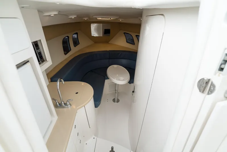  Yacht Photos Pics Interior of 2010 Intrepid 370 Cuddy with seating and compact kitchenette.
