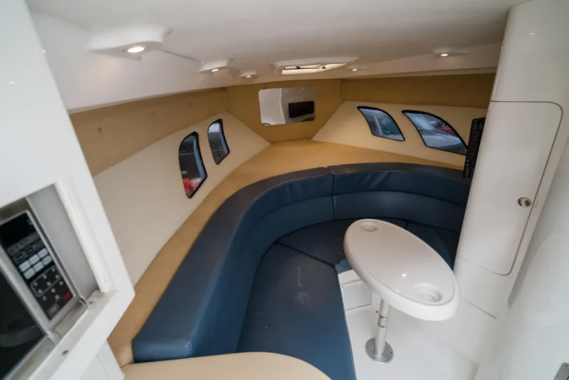  Yacht Photos Pics 2010 Intrepid 370 Cuddy interior with blue seating and round table.