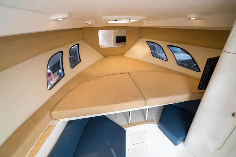  Yacht Photos Pics 2010 Intrepid 370 Cuddy cabin interior with beige cushions and windows.