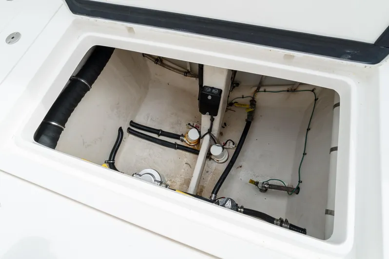  Yacht Photos Pics Intrepid 370 Cuddy 2010 boat storage compartment with visible wiring and plumbing.