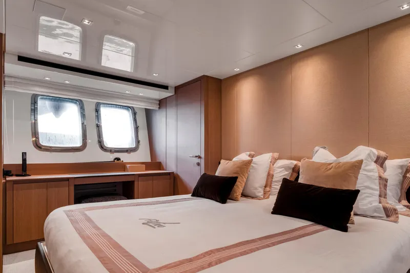  Yacht Photos Pics Luxurious bedroom interior of 2024 Sanlorenzo SX76 yacht with elegant decor and large windows.
