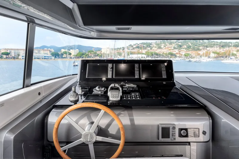  Yacht Photos Pics 2024 Sanlorenzo SX76 yacht helm with modern navigation equipment and scenic harbor view.