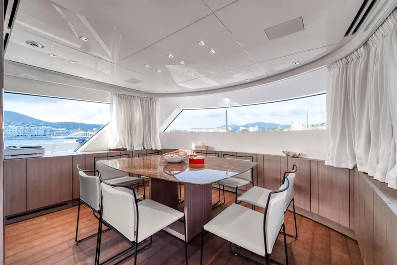  Yacht Photos Pics Luxurious dining area on 2024 Sanlorenzo SX76 yacht with panoramic windows and elegant decor.