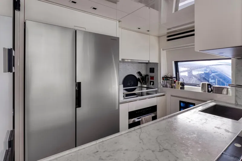  Yacht Photos Pics Modern kitchen in 2024 Sanlorenzo SX76 yacht with sleek appliances and marble countertops.