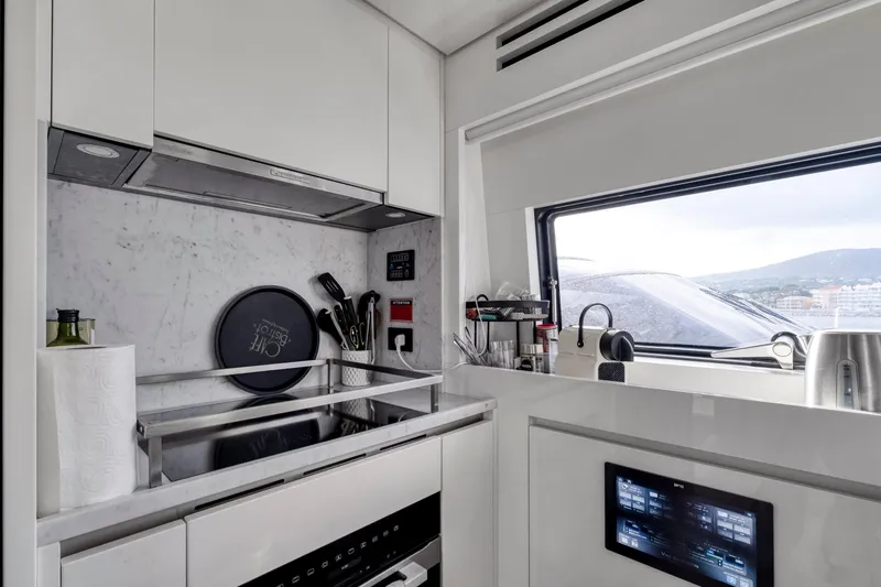  Yacht Photos Pics Modern kitchen in 2024 Sanlorenzo SX76 yacht with sleek design and advanced appliances.