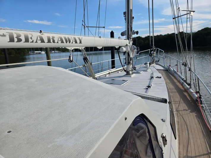 Bearaway Yacht Photos Pics 1985 Amel Maramu sailboat on calm water, featuring deck and mast.