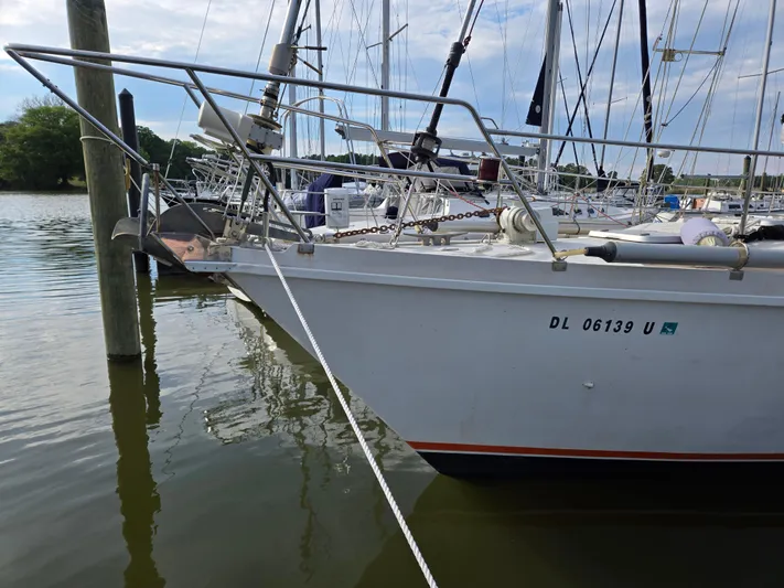 Bearaway Yacht Photos Pics 1985 Amel Maramu sailboat docked in a marina, featuring a sleek bow design.