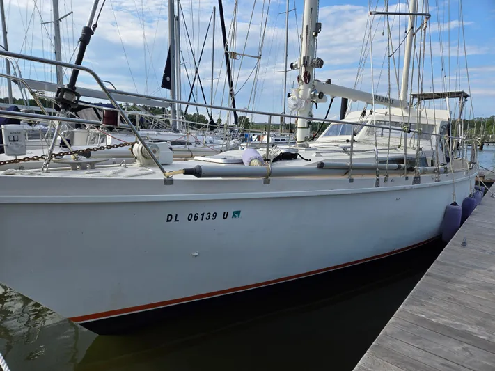 Bearaway Yacht Photos Pics 1985 Amel Maramu sailboat docked at a marina, showcasing its sleek design and sturdy build.