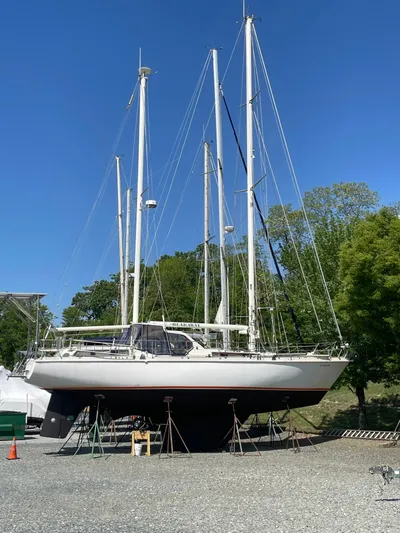 Bearaway Yacht Photos Pics 1985 Amel Maramu sailboat on stands, blue sky, trees in background.