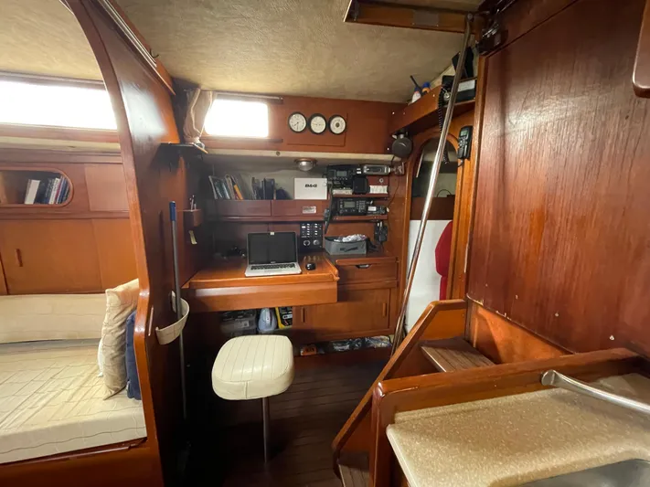Bearaway Yacht Photos Pics 1985 Amel Maramu yacht interior with navigation station and wooden furnishings.