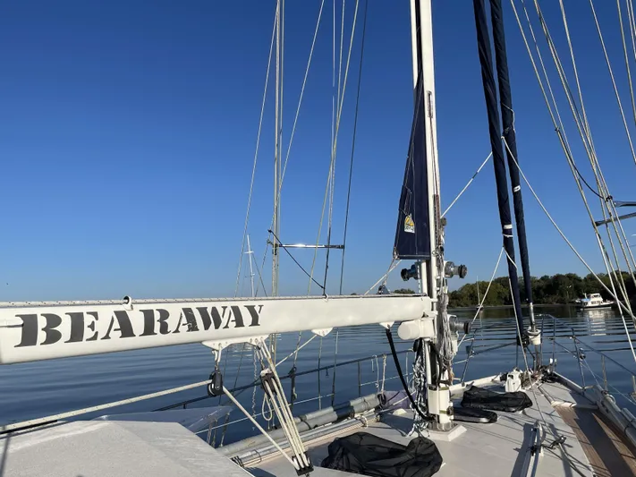 Bearaway Yacht Photos Pics Sailboat "Bearaway" on calm water, Amel Maramu 1985 model, clear blue sky.
