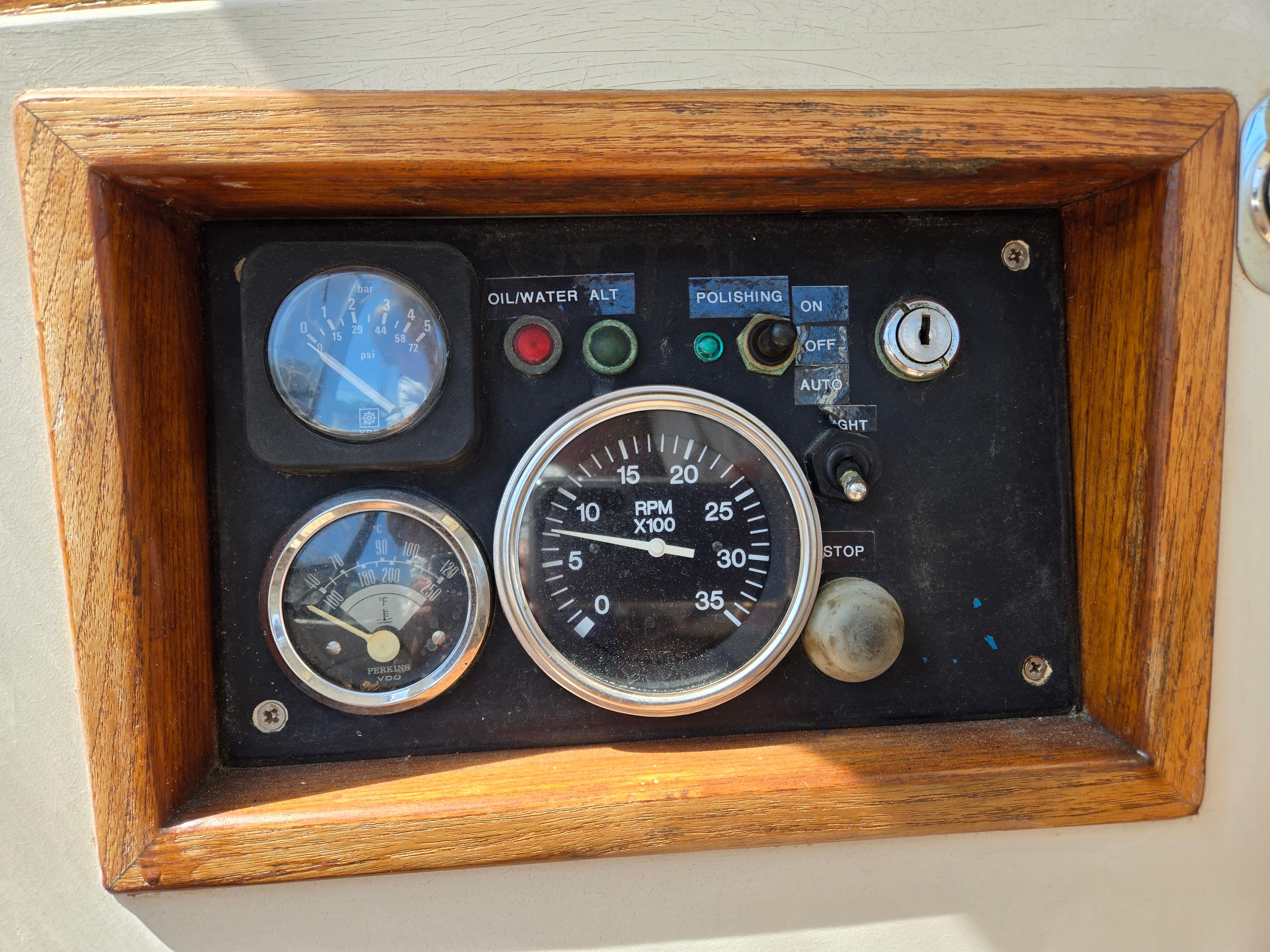 Control panel of a 1985 Amel Maramu sailboat with gauges and switches.