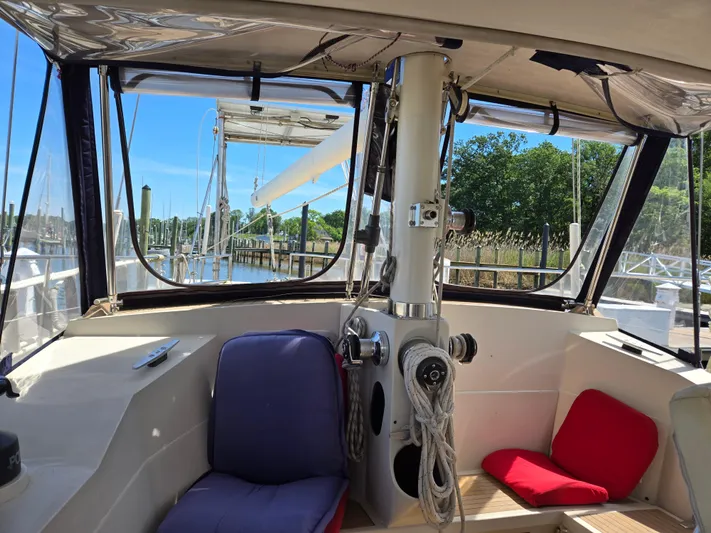 Bearaway Yacht Photos Pics Interior view of 1985 Amel Maramu sailboat cockpit with seating and ropes.