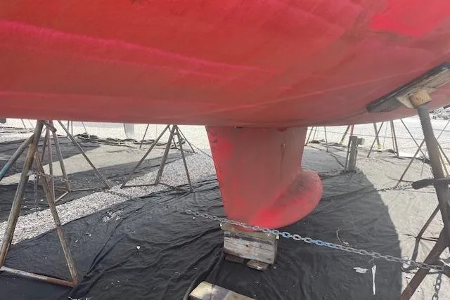 Ligera Yacht Photos Pics Red hull of 2002 Jeanneau Sun Odyssey 45.2 sailboat on stands.