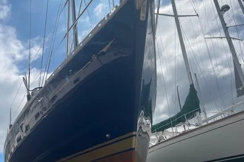 Ligera Yacht Photos Pics 2002 Jeanneau Sun Odyssey 45.2 sailboat with blue hull, docked under cloudy sky.