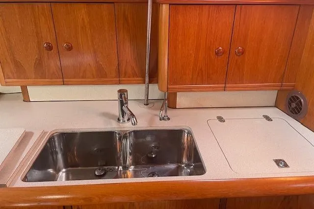 Ligera Yacht Photos Pics Jeanneau Sun Odyssey 45.2 2002 yacht kitchen with double sink and wooden cabinets.