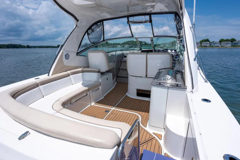 Latitude Adjustment Yacht Photos Pics 2013 Sea Ray 370 Sundancer yacht interior with seating and helm, on calm water.