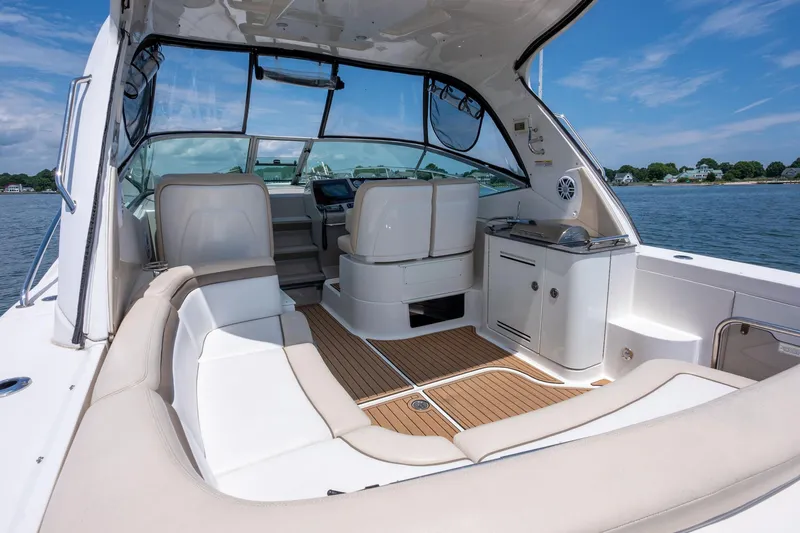 Latitude Adjustment Yacht Photos Pics Interior view of 2013 Sea Ray 370 Sundancer yacht with seating and helm.