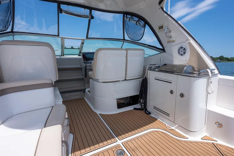 Latitude Adjustment Yacht Photos Pics Luxurious interior of 2013 Sea Ray 370 Sundancer yacht with seating and kitchenette.