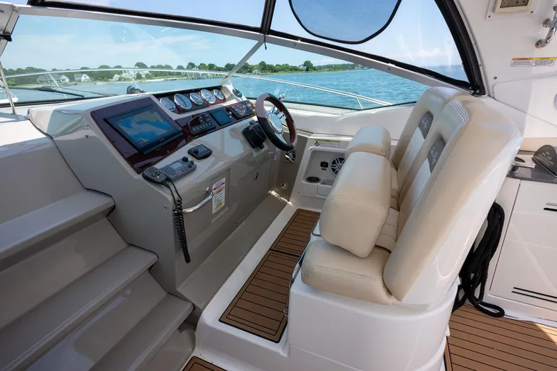 Latitude Adjustment Yacht Photos Pics 2013 Sea Ray 370 Sundancer helm with dual seats, modern controls, and ocean view.