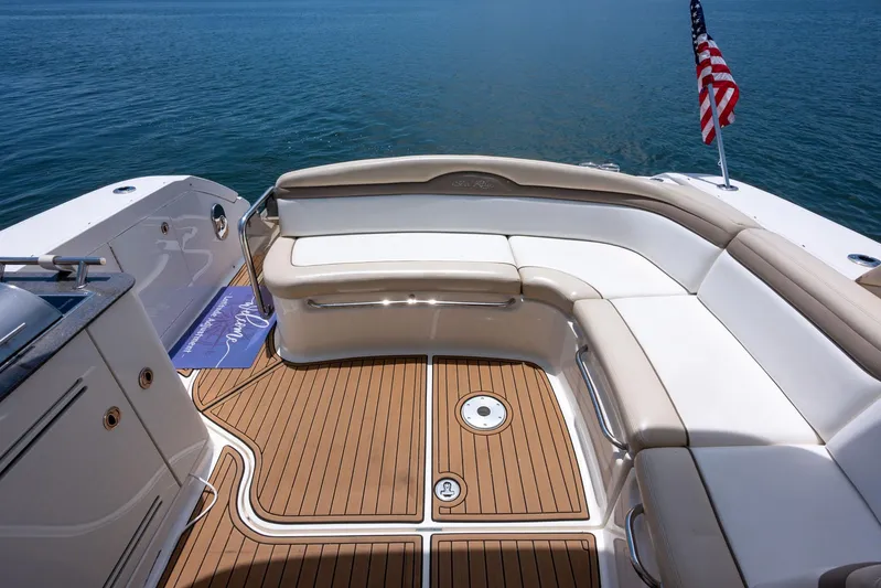 Latitude Adjustment Yacht Photos Pics 2013 Sea Ray 370 Sundancer yacht with elegant seating and American flag on calm water.