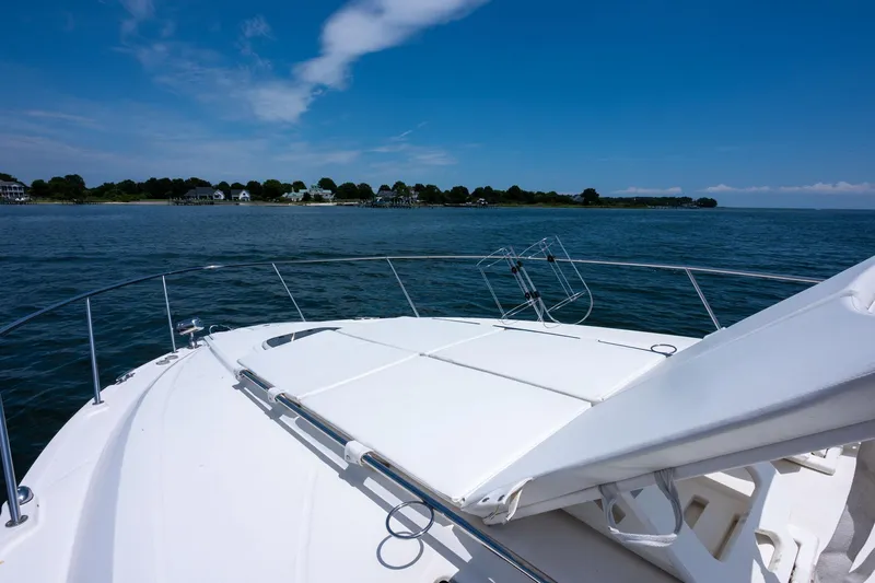 Latitude Adjustment Yacht Photos Pics 2013 Sea Ray 370 Sundancer cruising on calm waters under a clear blue sky.